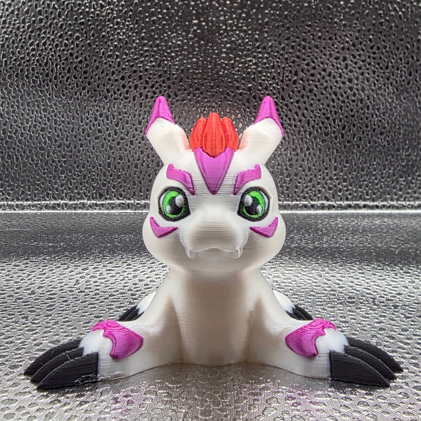 Toy figure of a creature with white, purple, and black colors on a textured surface