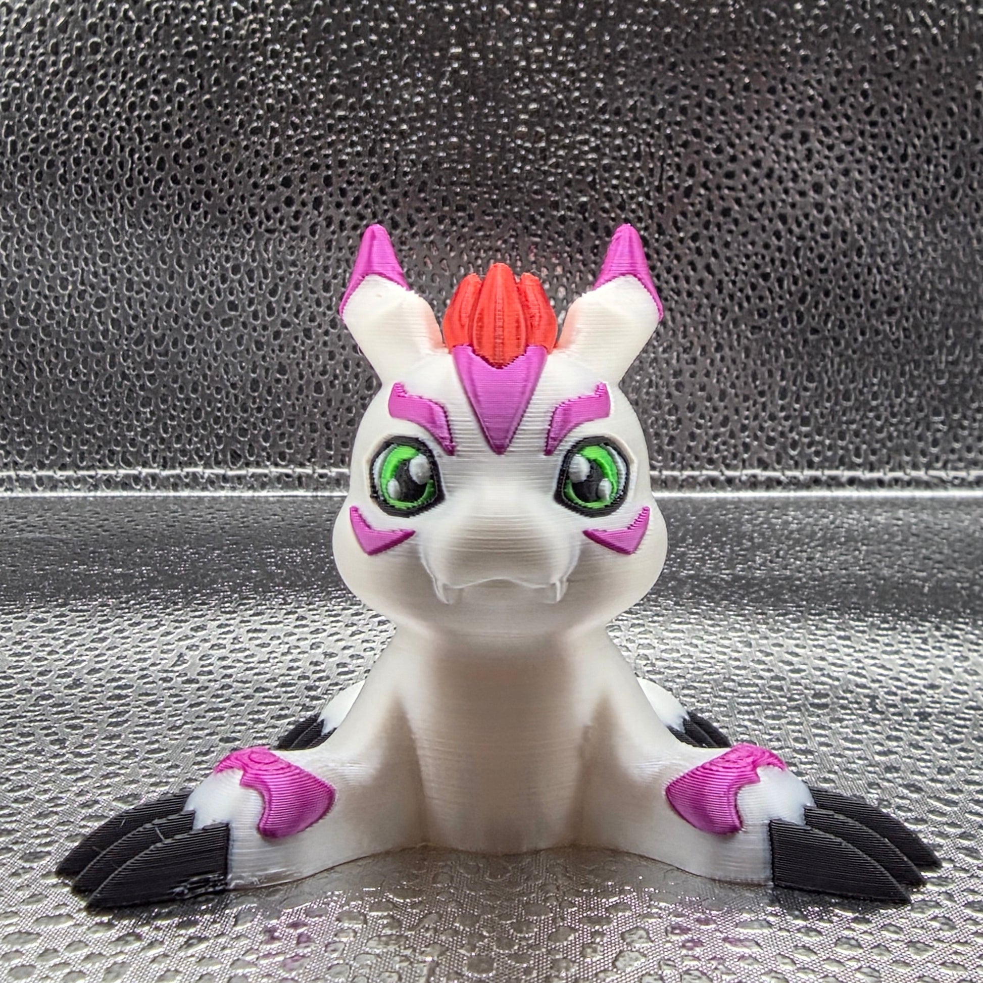 Toy figure of a creature with white, purple, and black colors on a textured surface