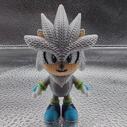 Crocheted character on a textured glass surface